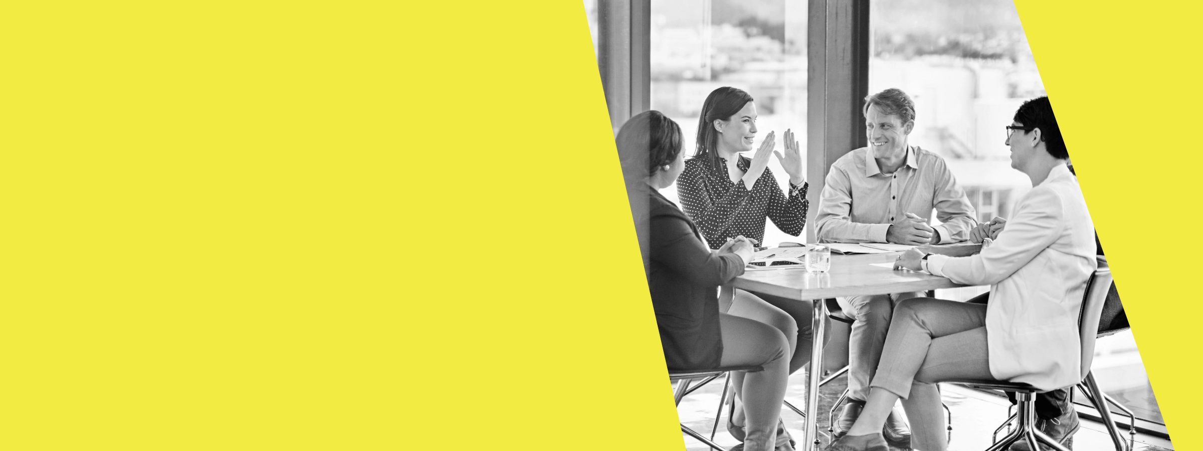 Five people gathered around a table having a positive discussion