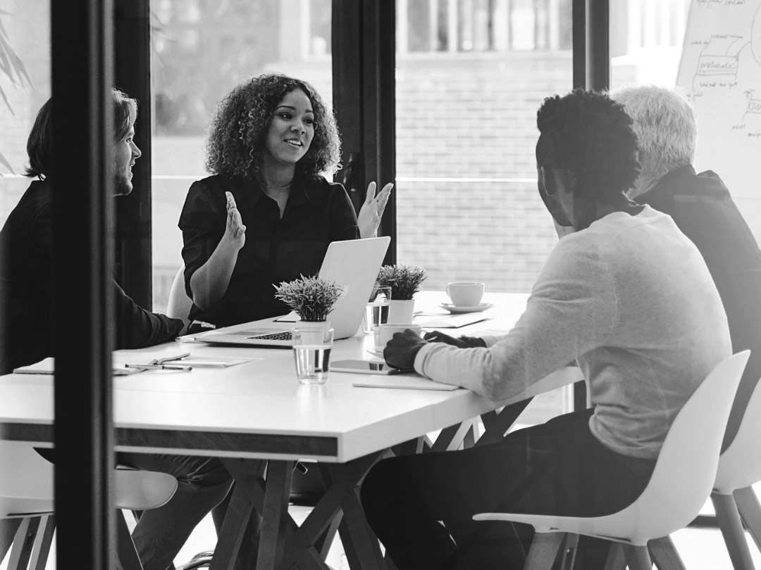 A small team of four people having a positive discussion
